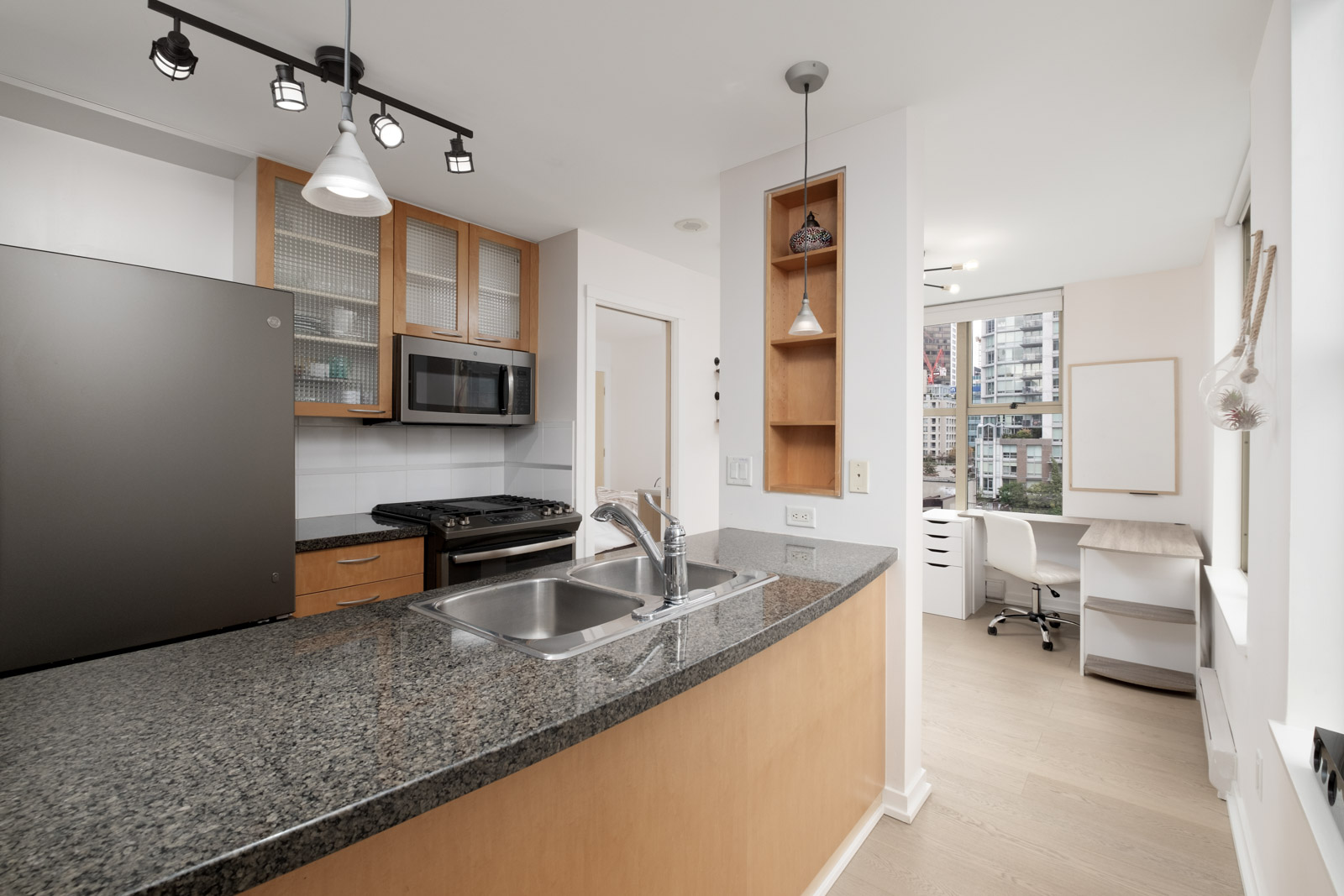 kitchen with stove fridge and island in rental condo fully furnished at mondrian 2 building in yaletown neighbourhood of downtown vancouver