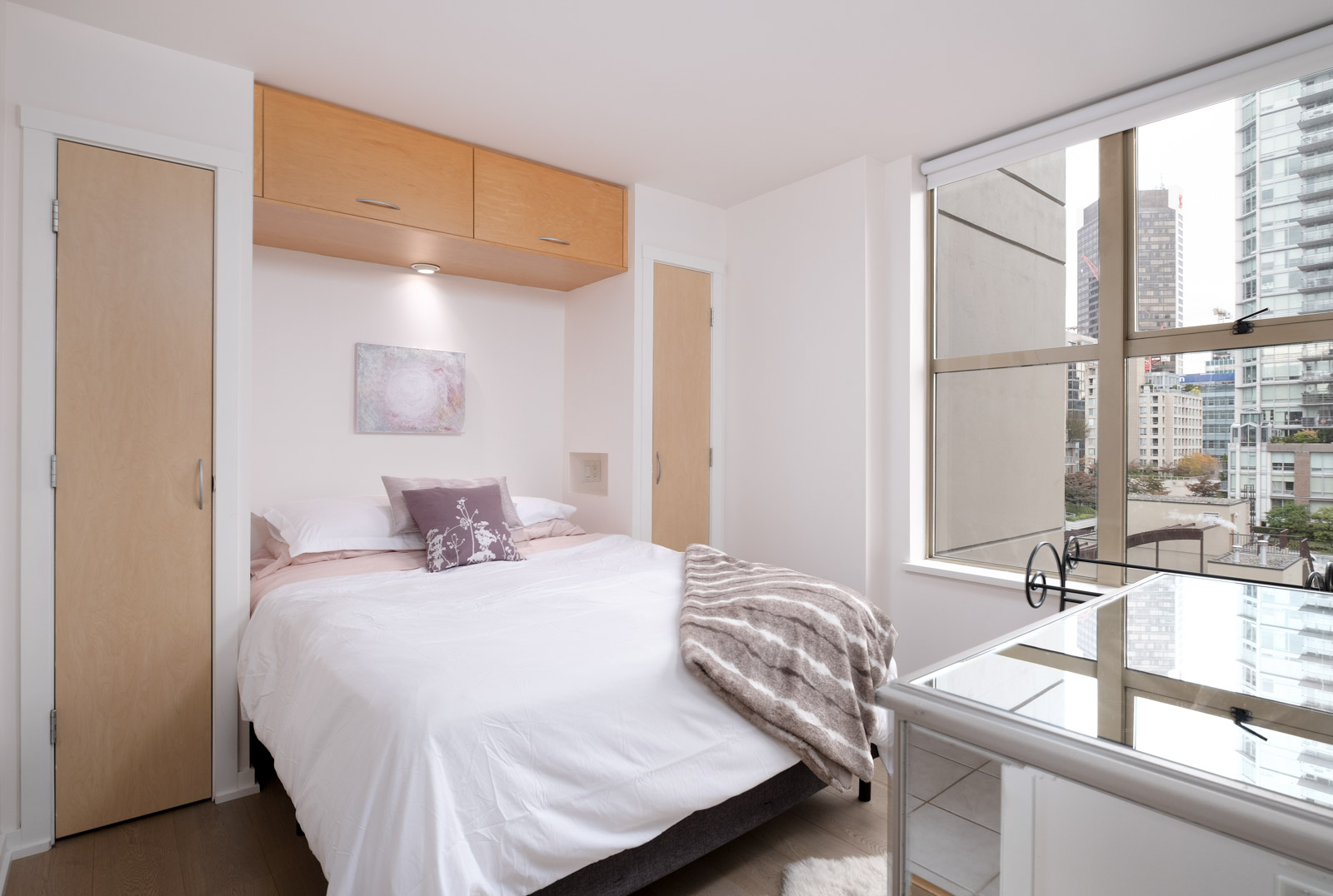 bed and dressor in rental condo at mondrian 2 in yaletown neighbourhood of downtown vancouver
