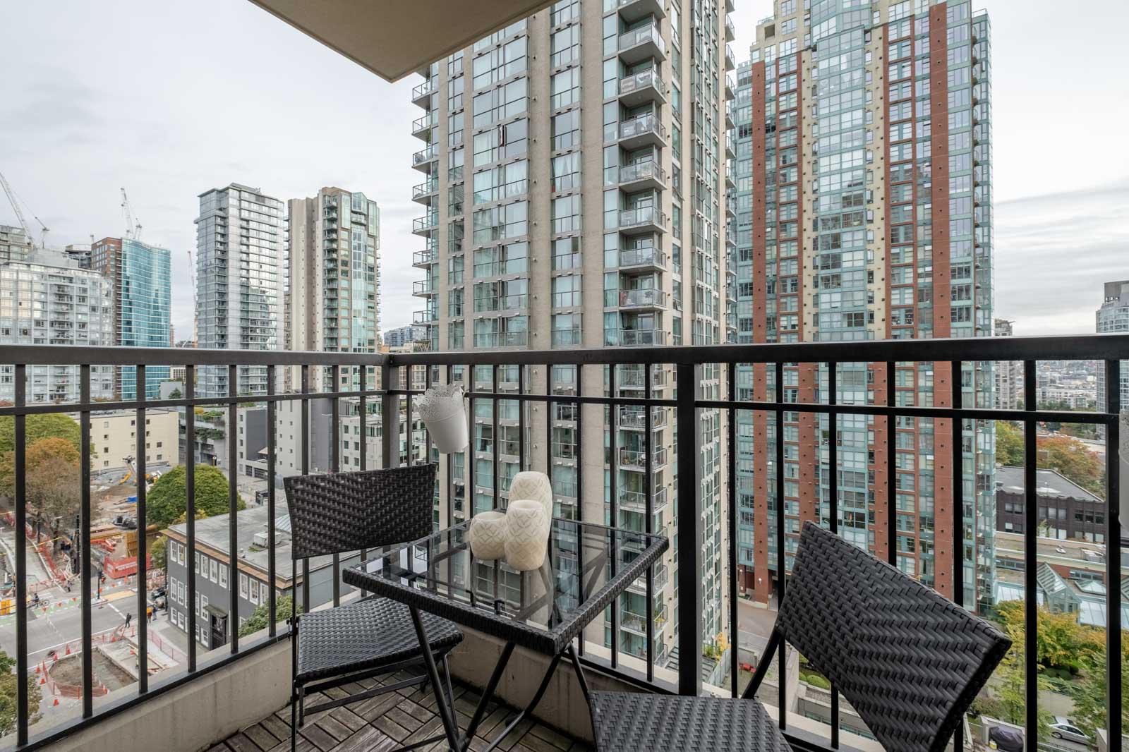 balcony with chairs and table in rental condo managed by birds nest properties at mondrian 2 building in yaletown vancouver