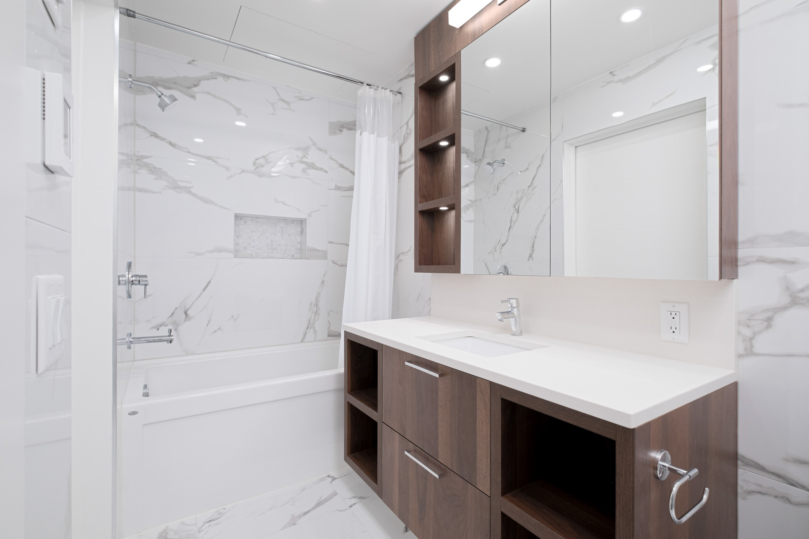bathroom with marble tiling and vanity and mirror in rental condo at basalt on cambie in vancouver westside neighbourhood of vancouver