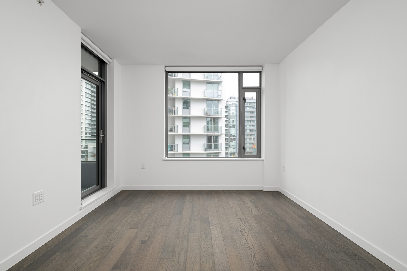 living room with hardwood floors and outdoor window in false creek olympic village rental condo managed by birds nest properties