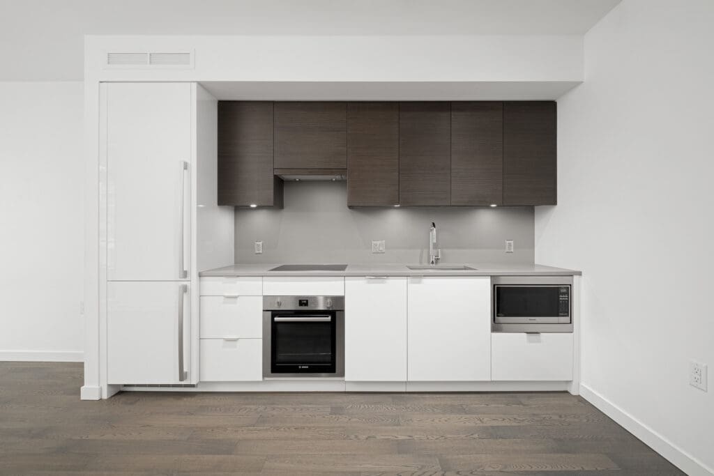 kitchen with dark cabinets and white countertop in rental condo in navio on pullman porter street in false creek olympic village