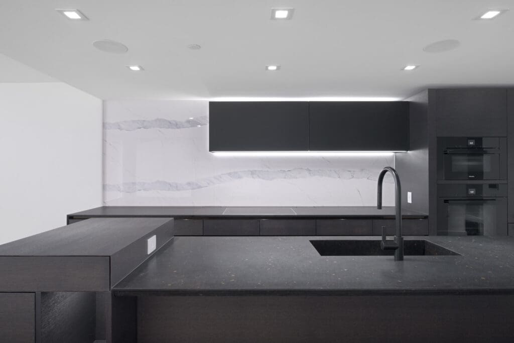kitchen with dark cabinets and led lights in rental condo kitchen in cardero building in coal harbour vancouver