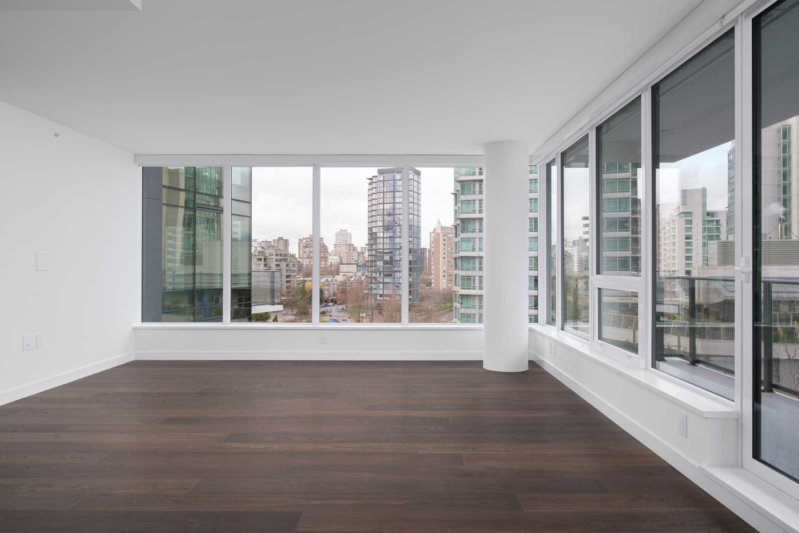 living room with dark hardwood flooring and wide windows in luxury rental condo at cardero