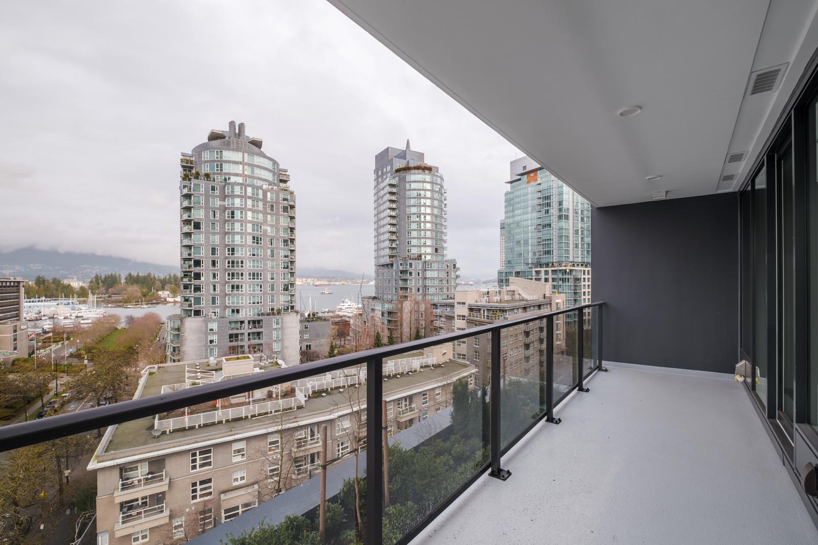 balcony of rental condo at cardero overlooking other buildings in coal harbour neighbourhood of downtown vancouver bc