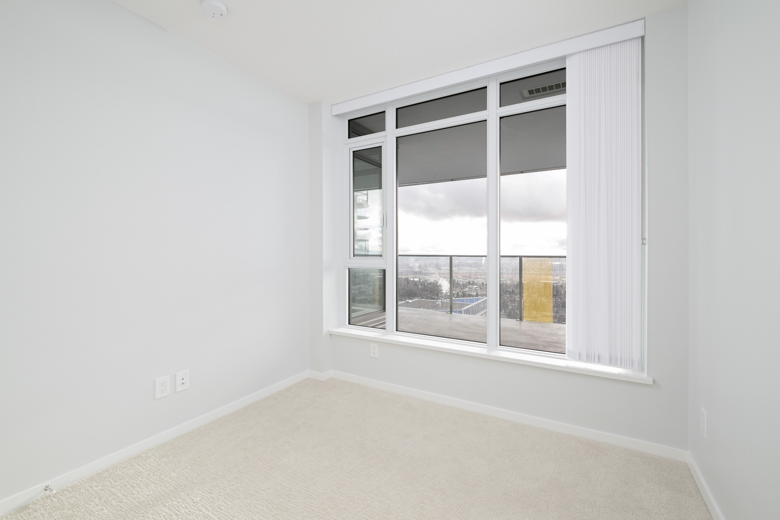 bedroom with white walls and window in rental condo in the Metrotown neighbourhood of Burnaby