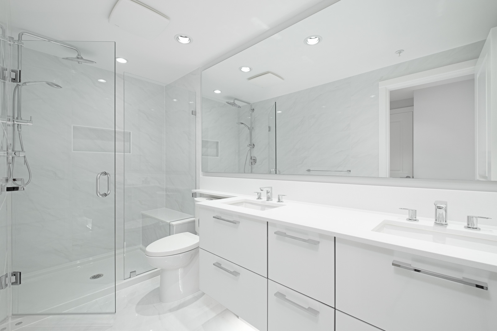 bathroom with white vanity and mirrors in rental condo at vittorio in the Metrotown neighbourhood of Burnaby