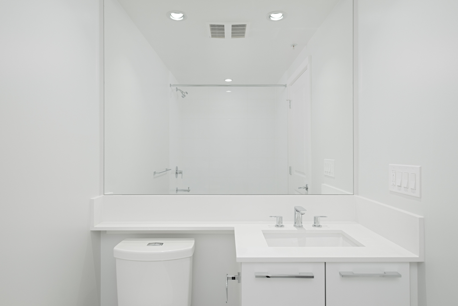bathroom with white vanity and mirrors in rental condo managed by birds nest properties at vittorio in the Metrotown neighbourhood of Burnaby