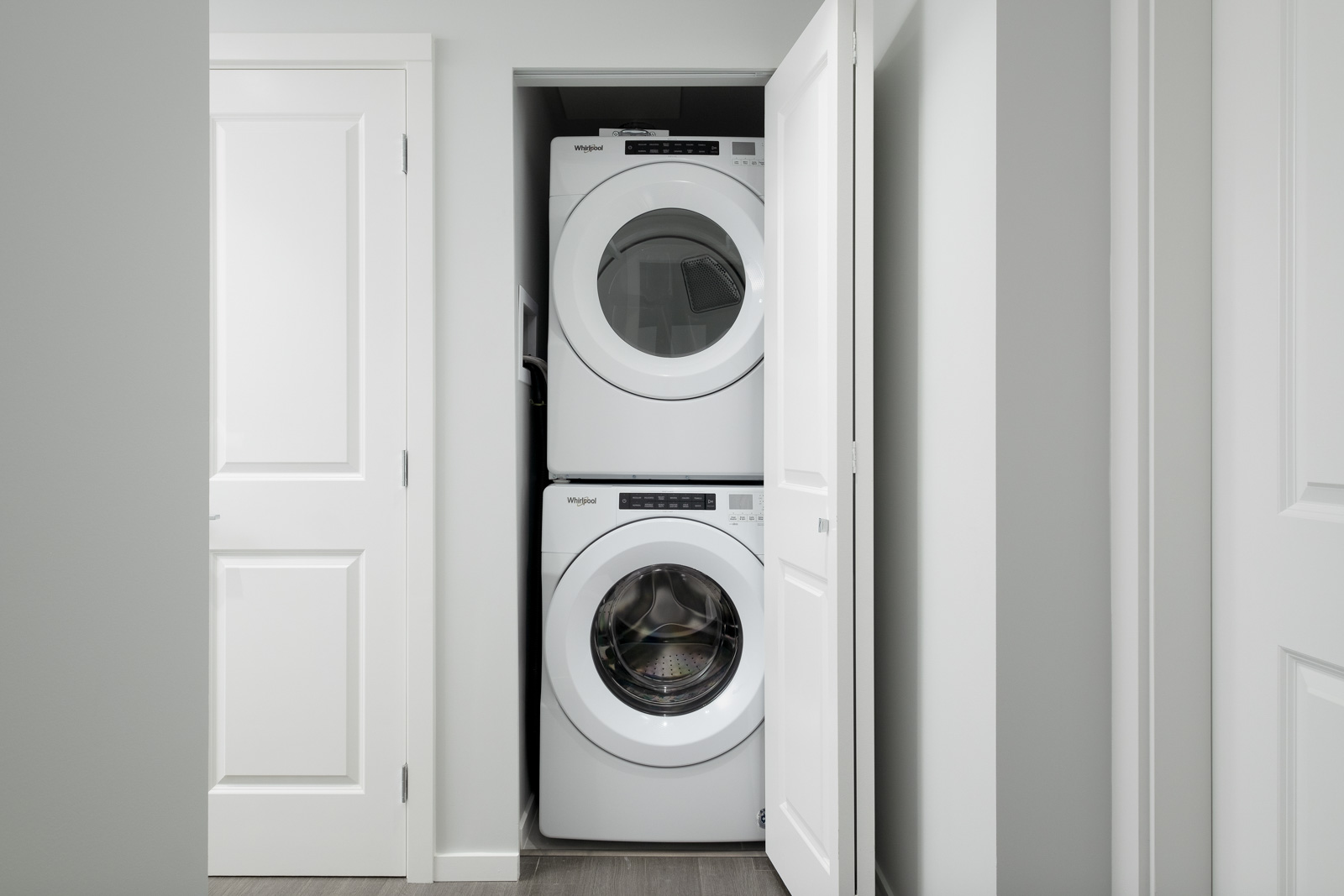 stacked white washer and dryer in rental condo presented by birds nest properties at vittorio by polygon in metrotown burnaby