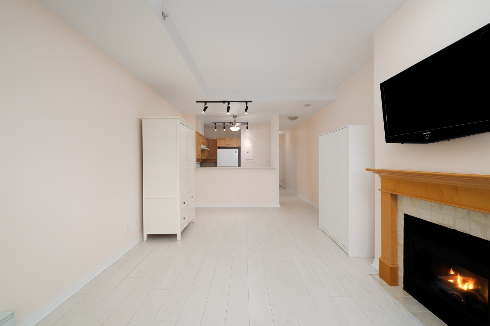living room with kitchen in background of kitsilano rental studio apartment in vancouver westside