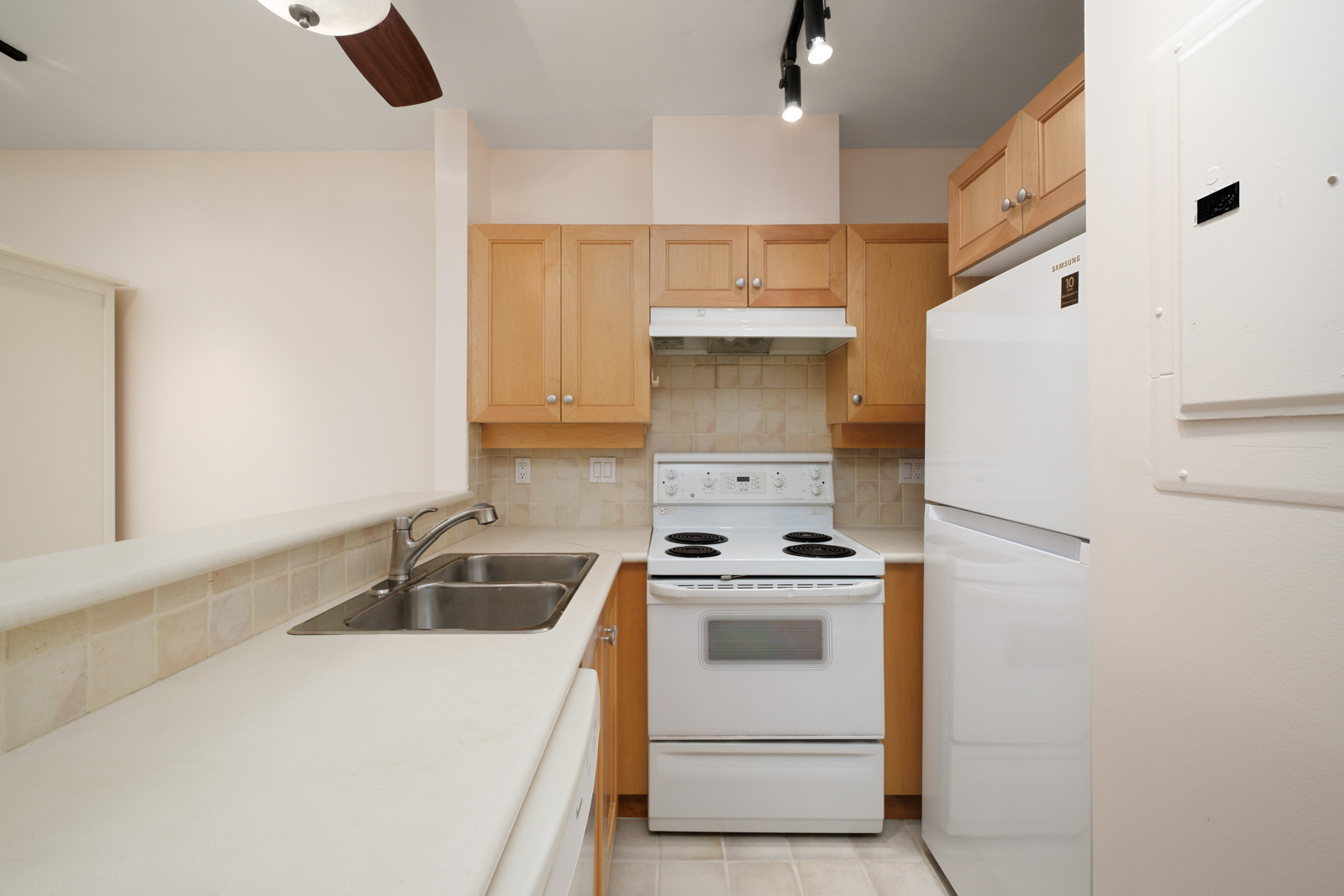 kitchen with white stove and wood cabinets in kitsilano rental studio apartment in vancouver westside