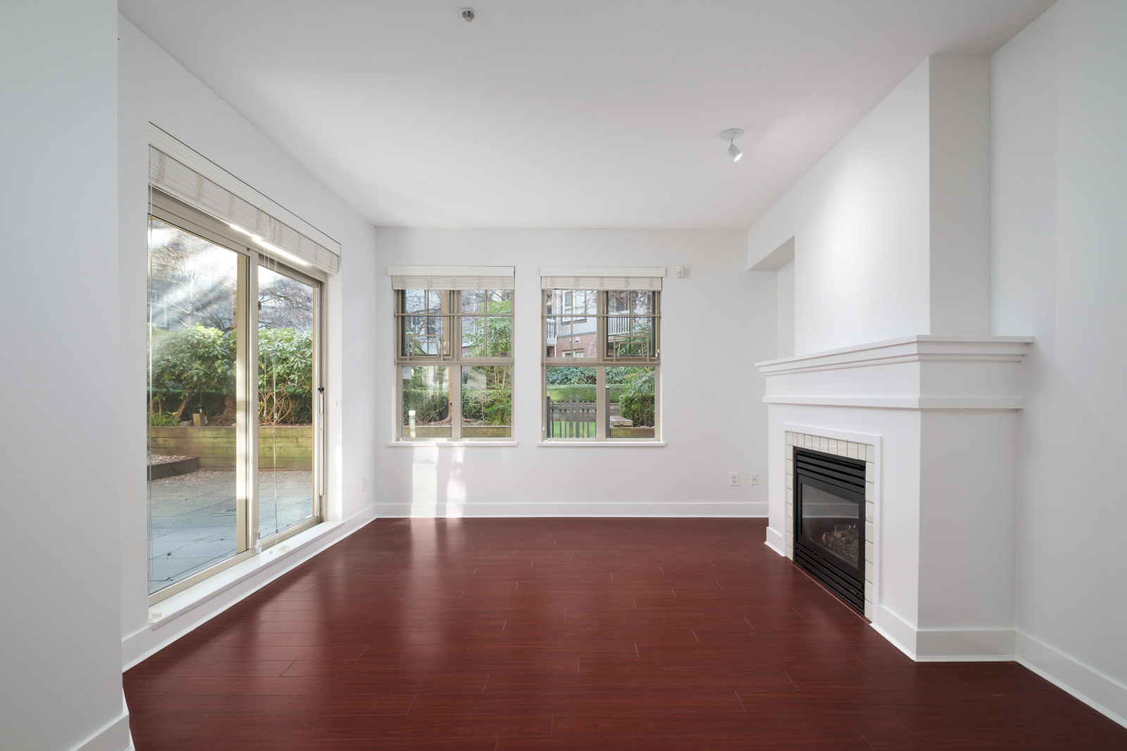 living room with fireplace in garden level apartment in alexandra house in shaughnessy of vancouver westside managed by birds nest properties