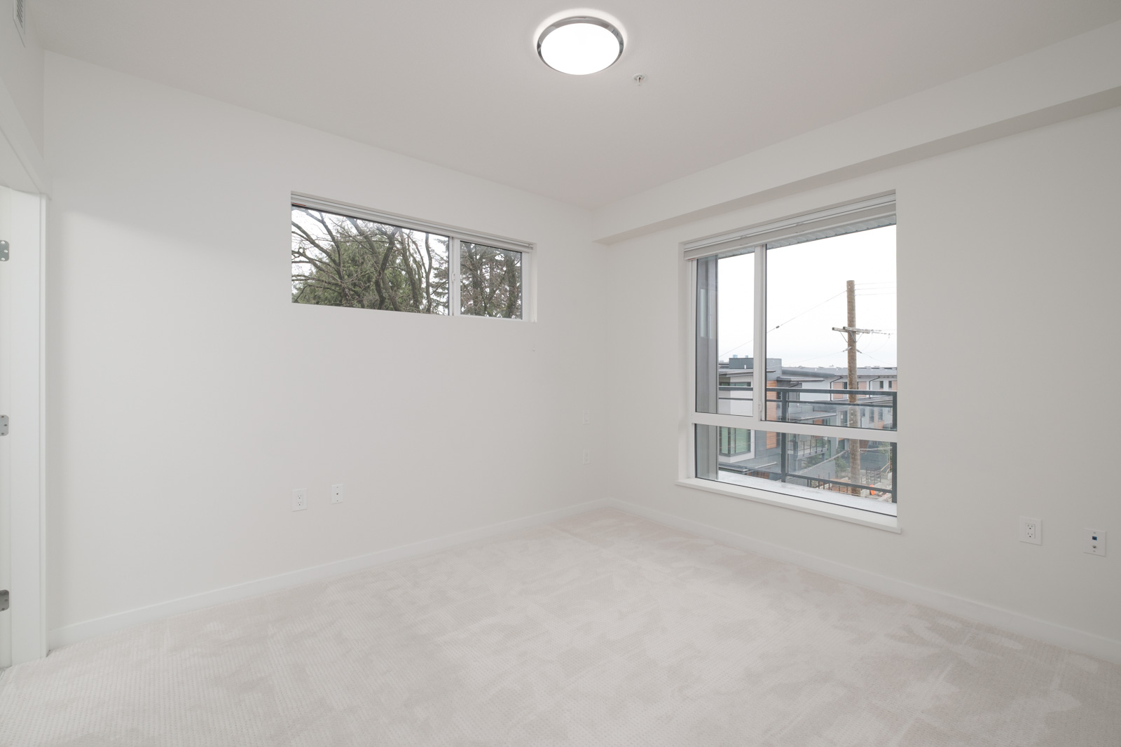 bedroom with white walls and window in rental condo in the Lonsdale neighbourhood of North Vancouver