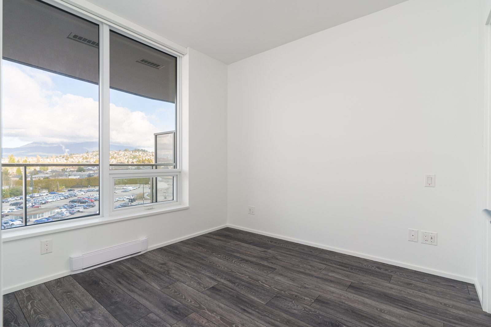 bedroom with white walls and window in rental condo in the Brentwood neighbourhood of burnaby