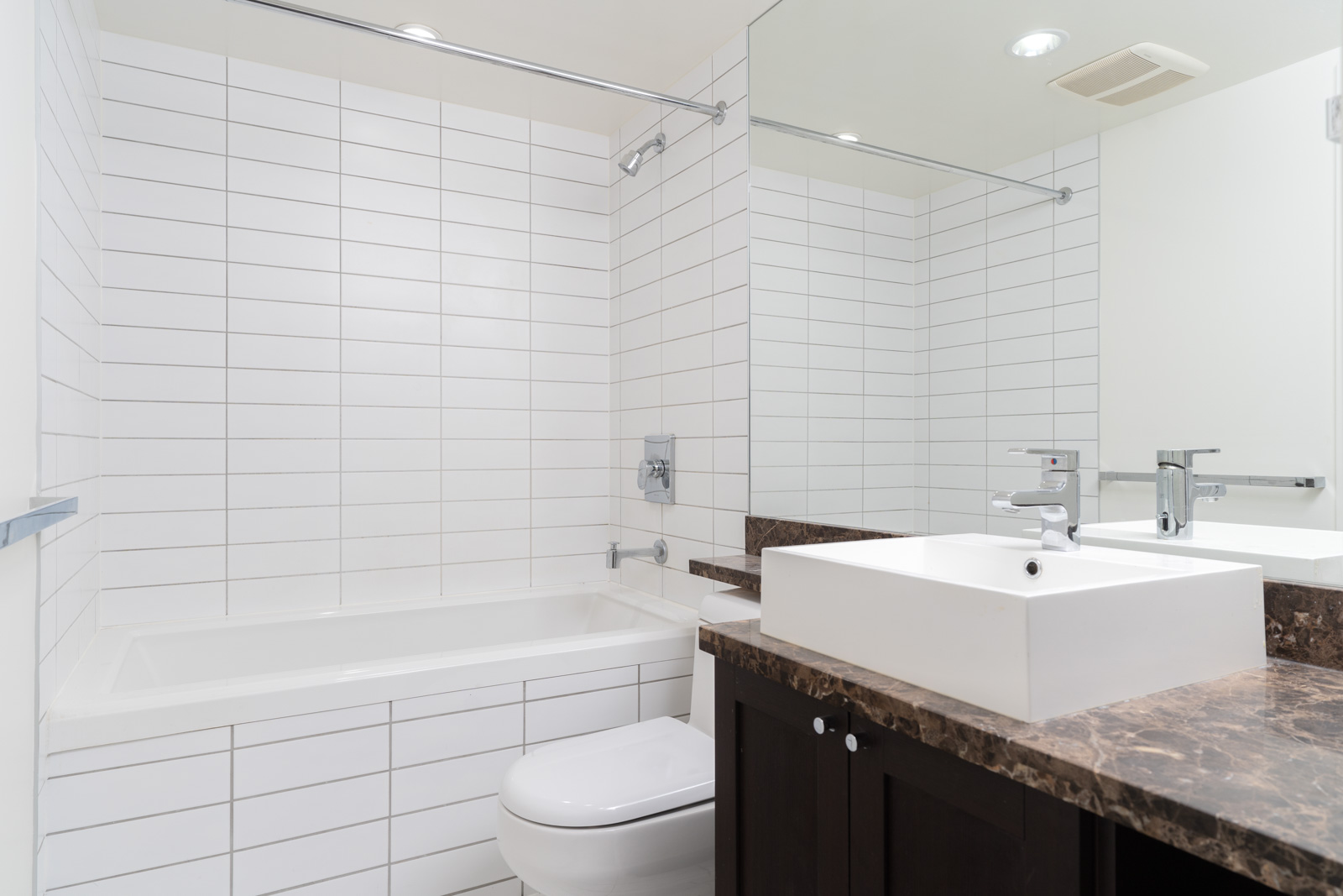 Bathroom with white walls and bathtub