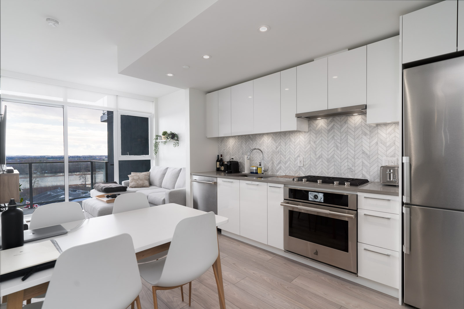 kitchen and living room view with laminate flooring in rental condo in the River District vancouver neighbourhood