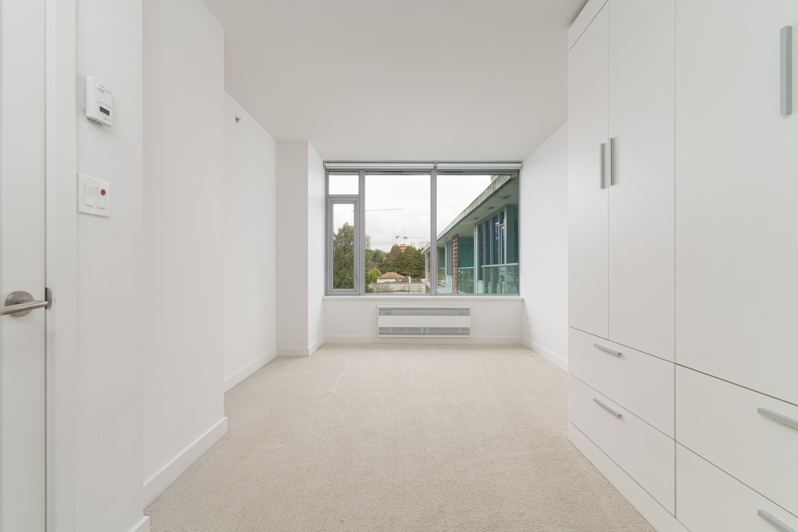 bedroom with white walls in rental house in the Marine Drive neighbourhood of Vancouver