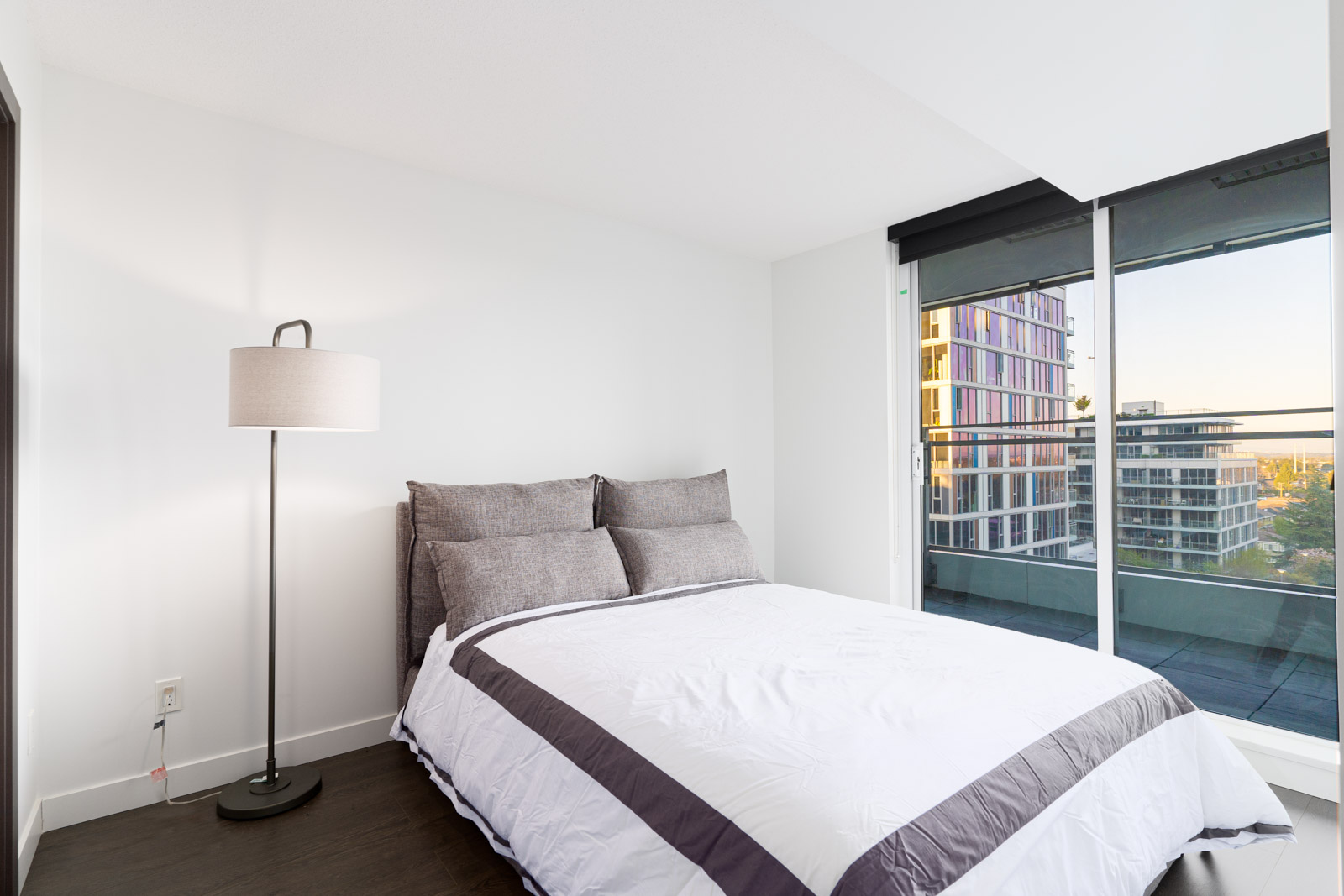bedroom with bed, lamp and window rented in a condo in richmond