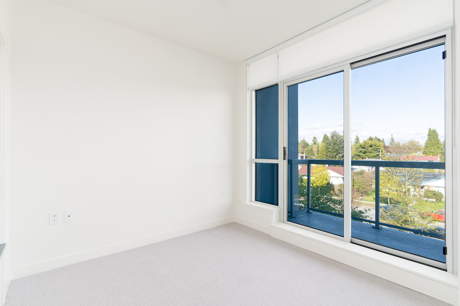 bedroom with white walls and window in rental condo in the Cambie neighbourhood of Vancouver