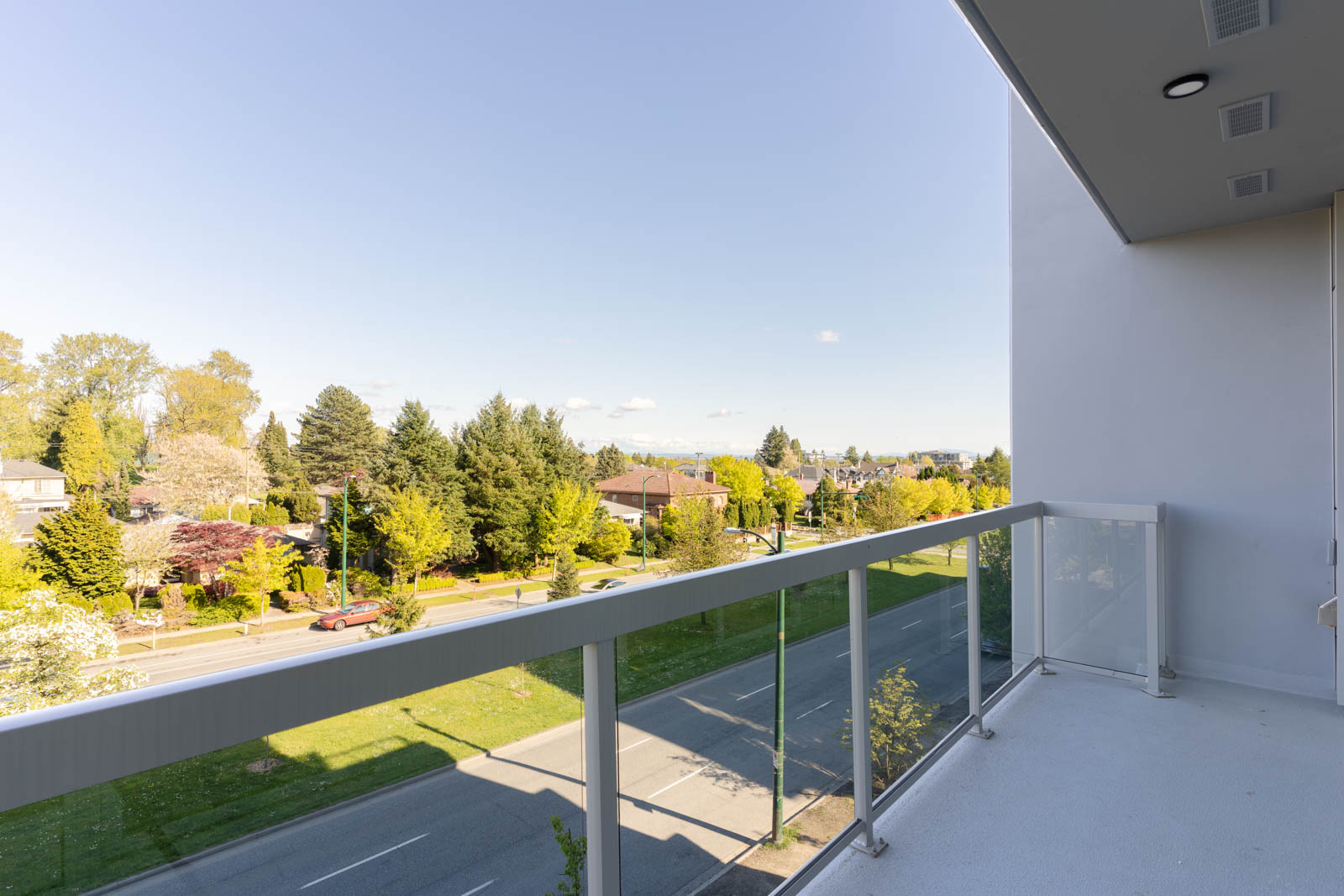 balcony with view of clear skies in rental condo in the Queen Elizabeth neighbourhood of Vancouver
