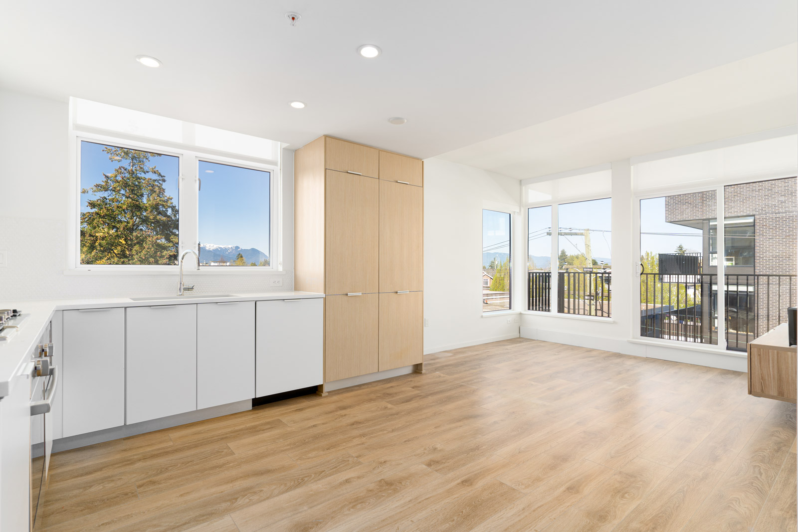 Open living space with hardwood floors and balcony