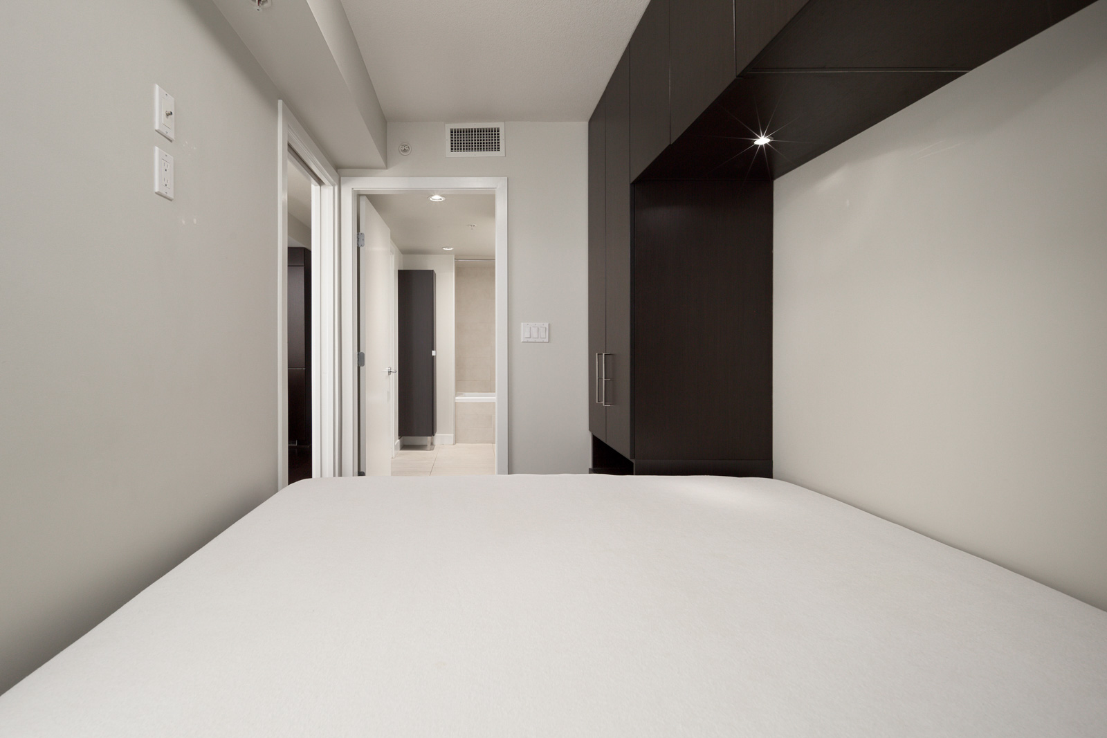 bedroom with white walls and window in rental condo in the Downtown neighbourhood of Vancouver