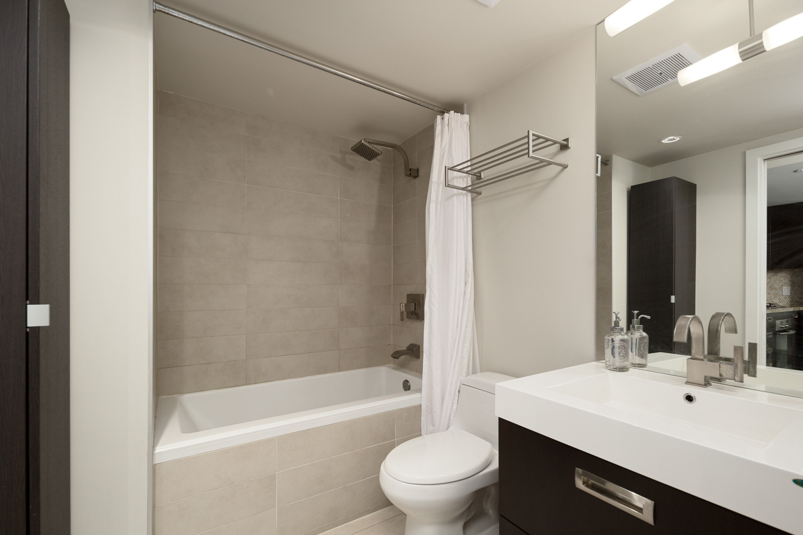 bathroom with tub and white walls