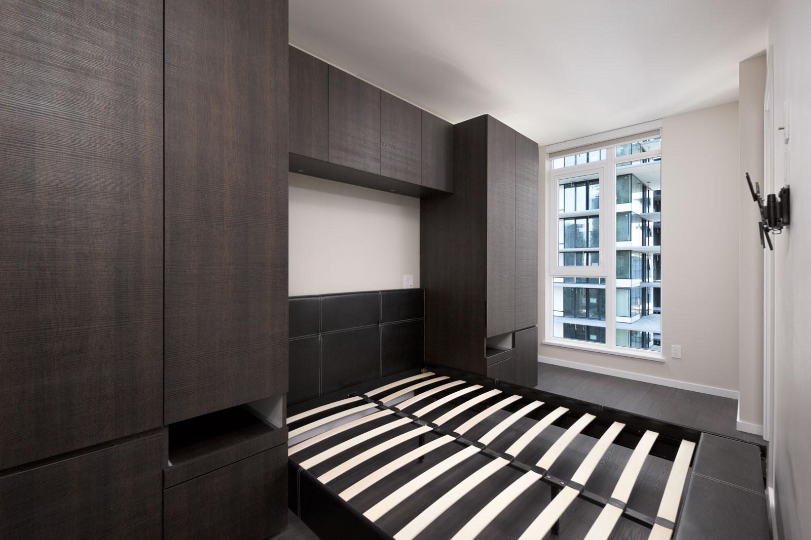 bedroom with closet in rental condo at Maddox in the Downtown neighbourhood of Vancouver bedroom with white walls and window in rental condo in the Downtown neighbourhood of Vancouver