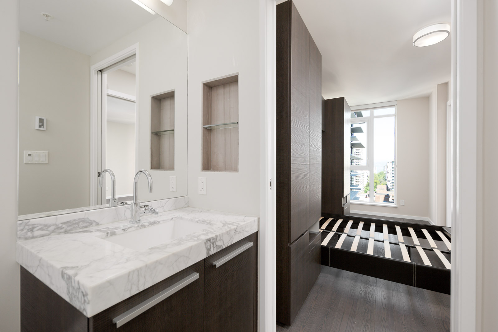marble countertop bathroom with white walls and big mirror