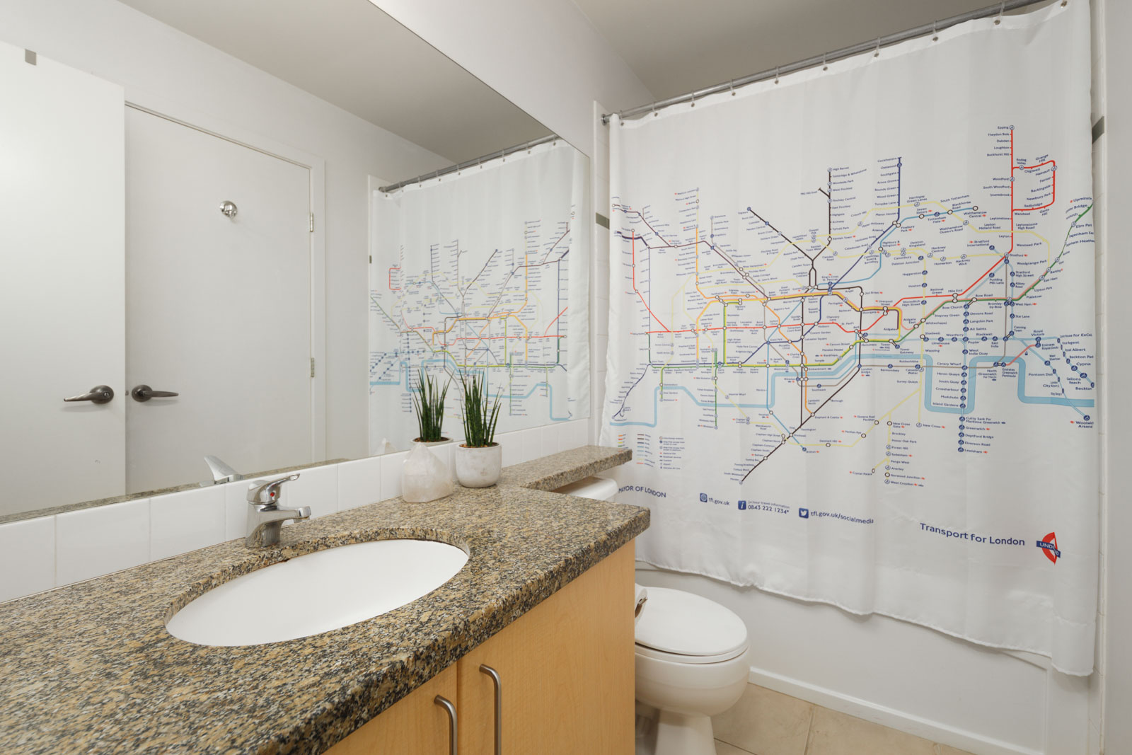 bathroom with tub and white walls