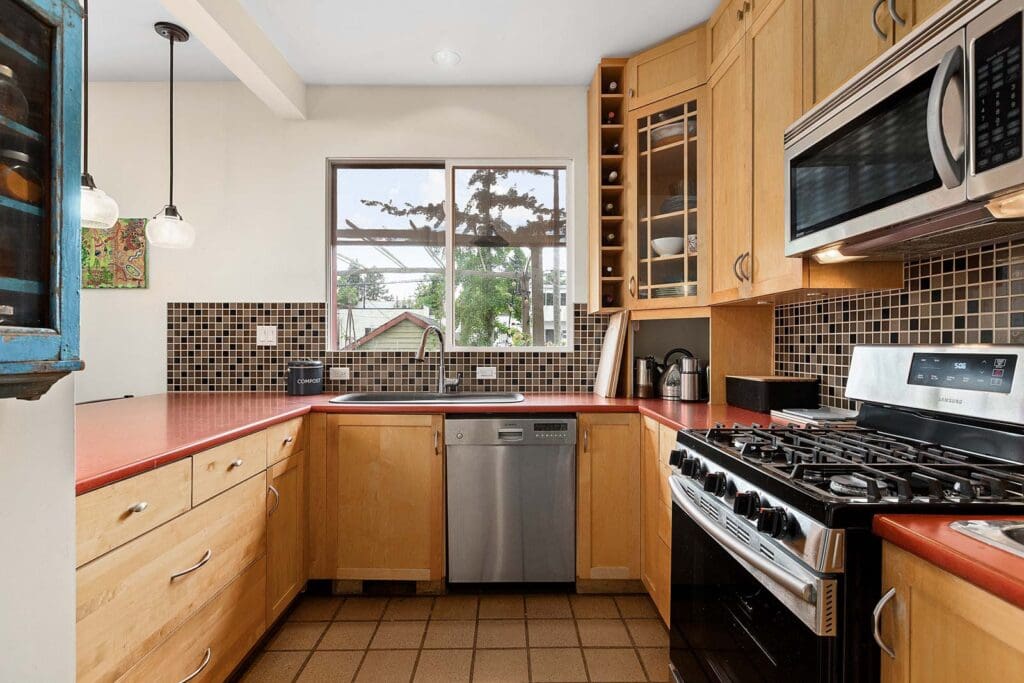 stainless steel appliances overlooking yard in East Vancouver home
