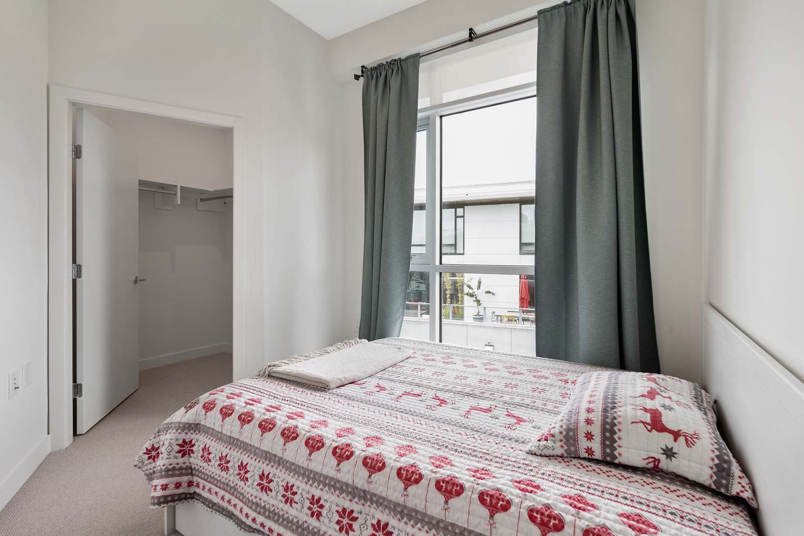 second bedroom with large windows that provides plenty of natural light flow through the unit