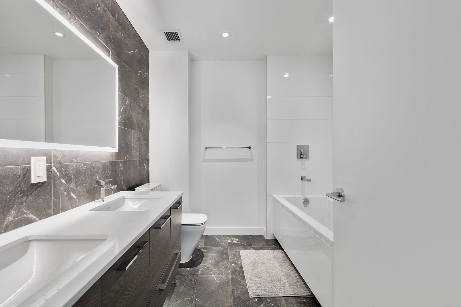 bathroom with tub and white walls