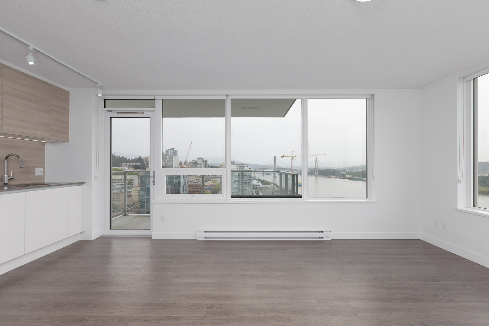 laminate floors and door to the balcony and big windows
