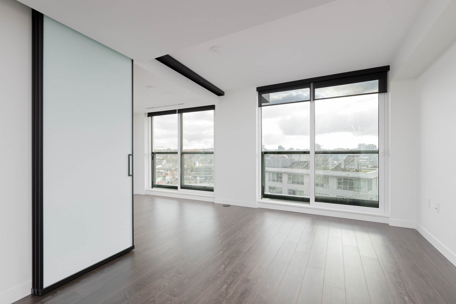 spacious living room in newly built Olympic Village condo