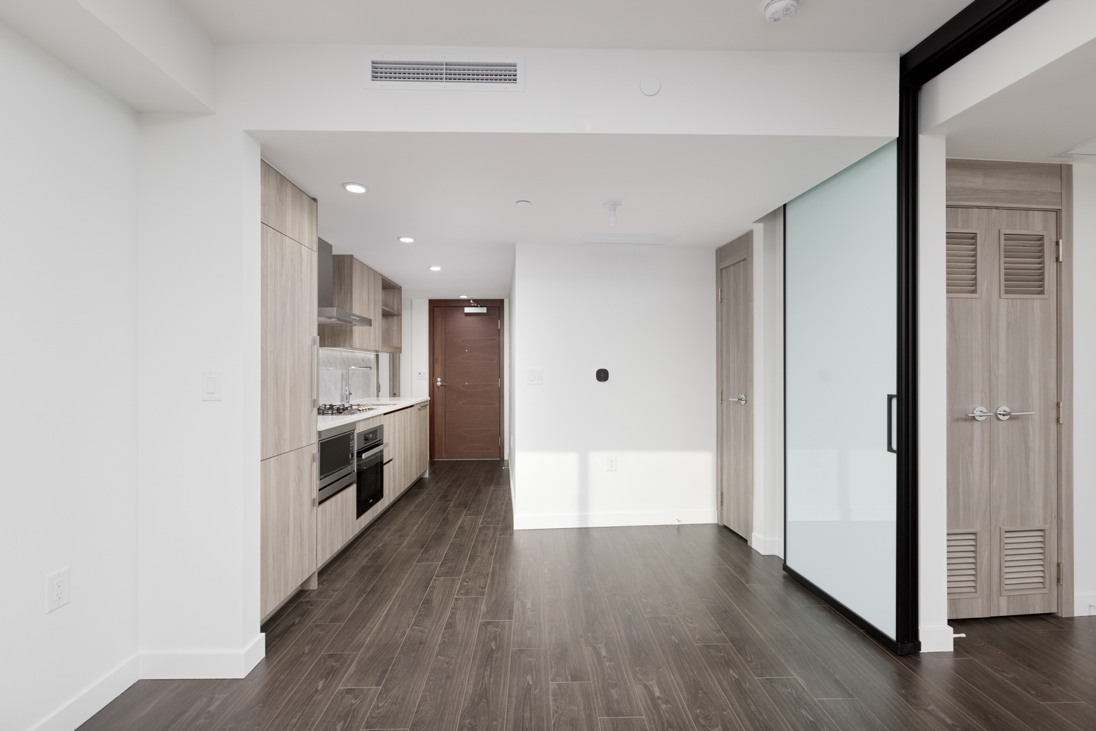 kitchen and living room in newly built Olympic Village condo
