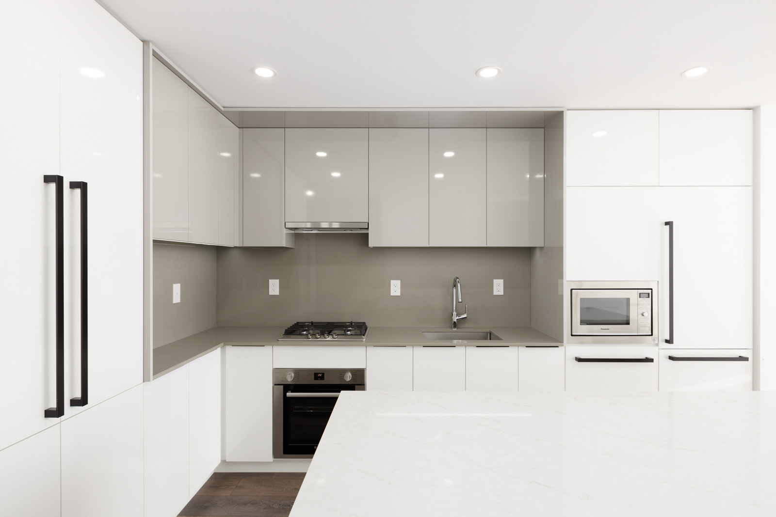 high end appliances and grey backsplash
