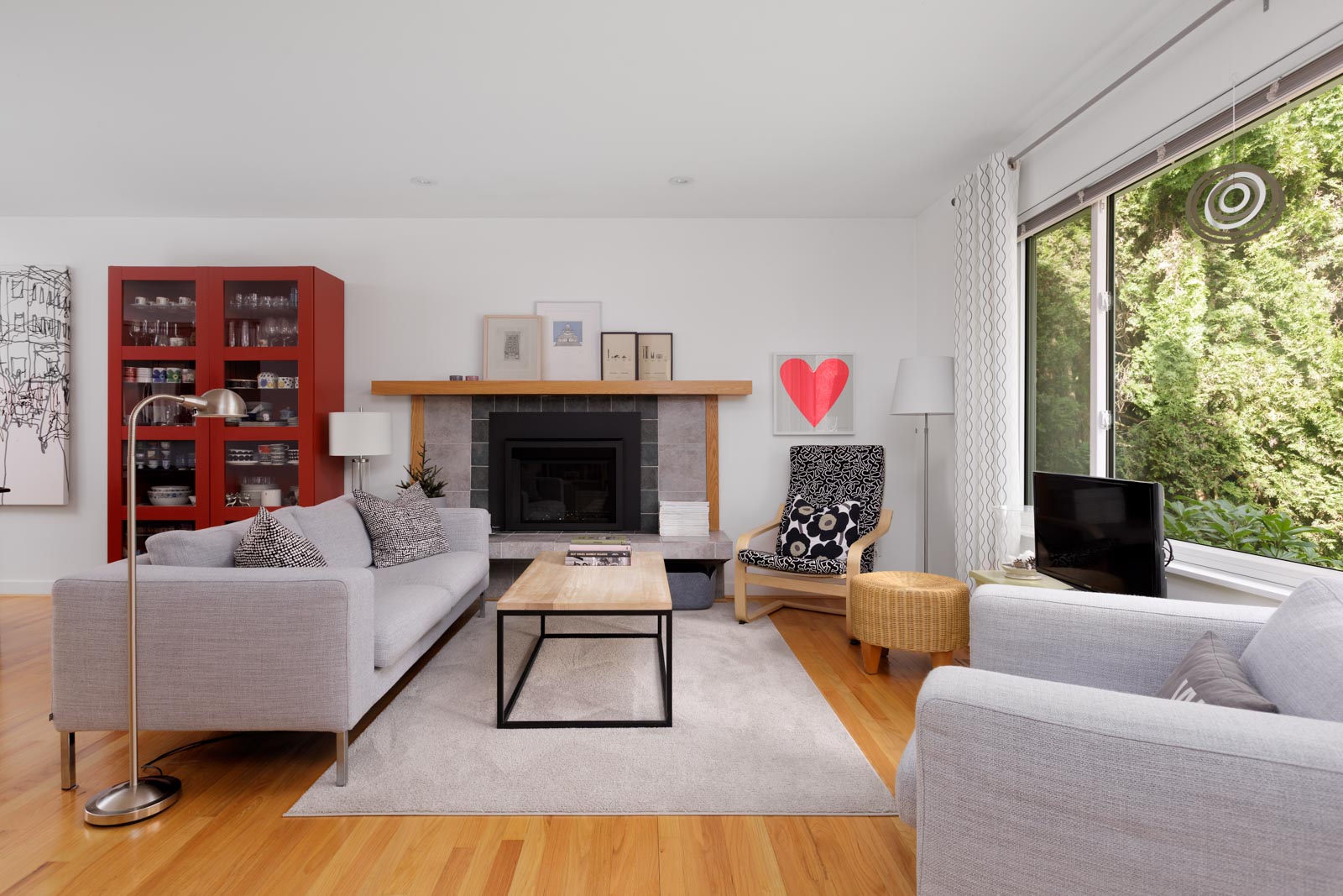 large bright living room with white walls and fireplace