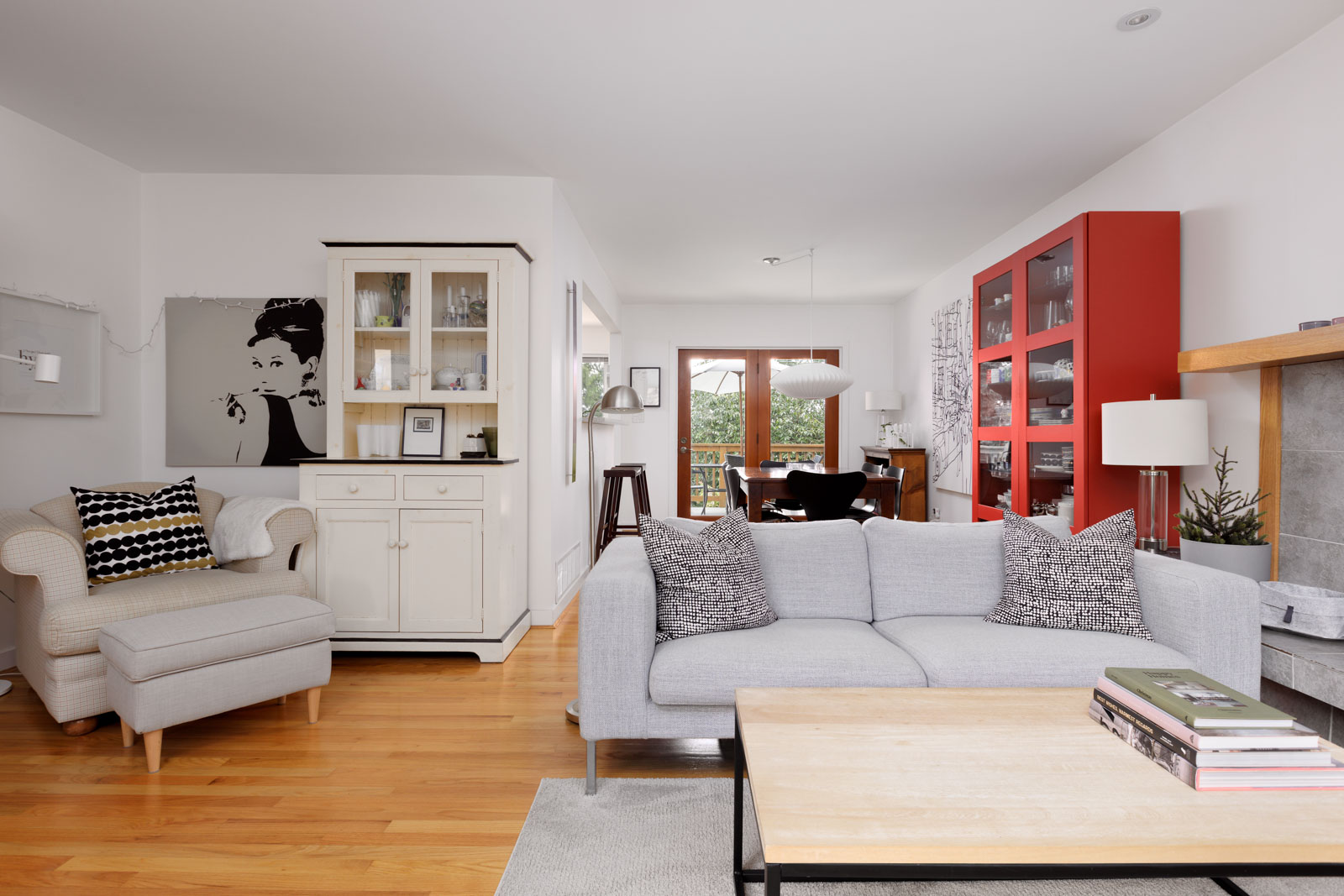 living room area with view of dining room, back door to deck, light hardwood flooring