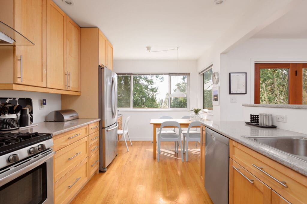 kitchen with hardwood floors, bright open space and large windows