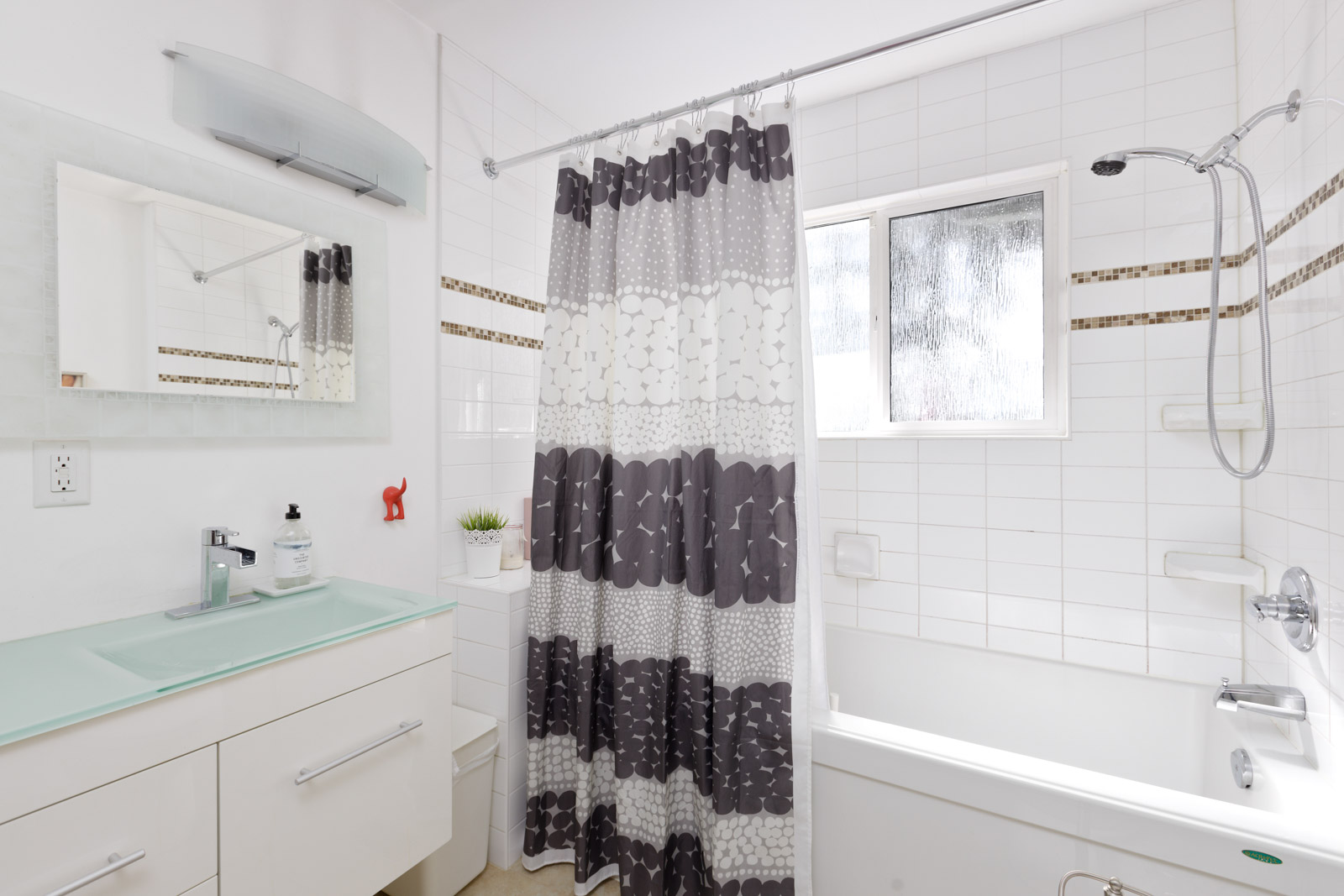 full washroom with tub, sink and cabinets. all white