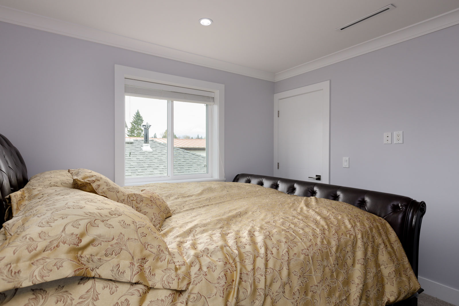 bedroom with closet door and light purple walls