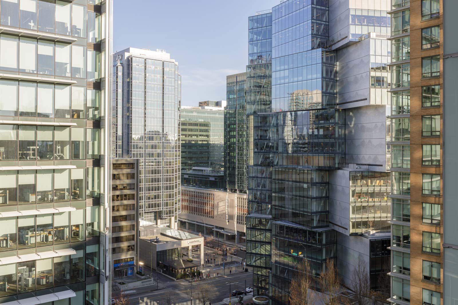 High-rise office buildings with glass exteriors in a modern urban area under a clear sky.