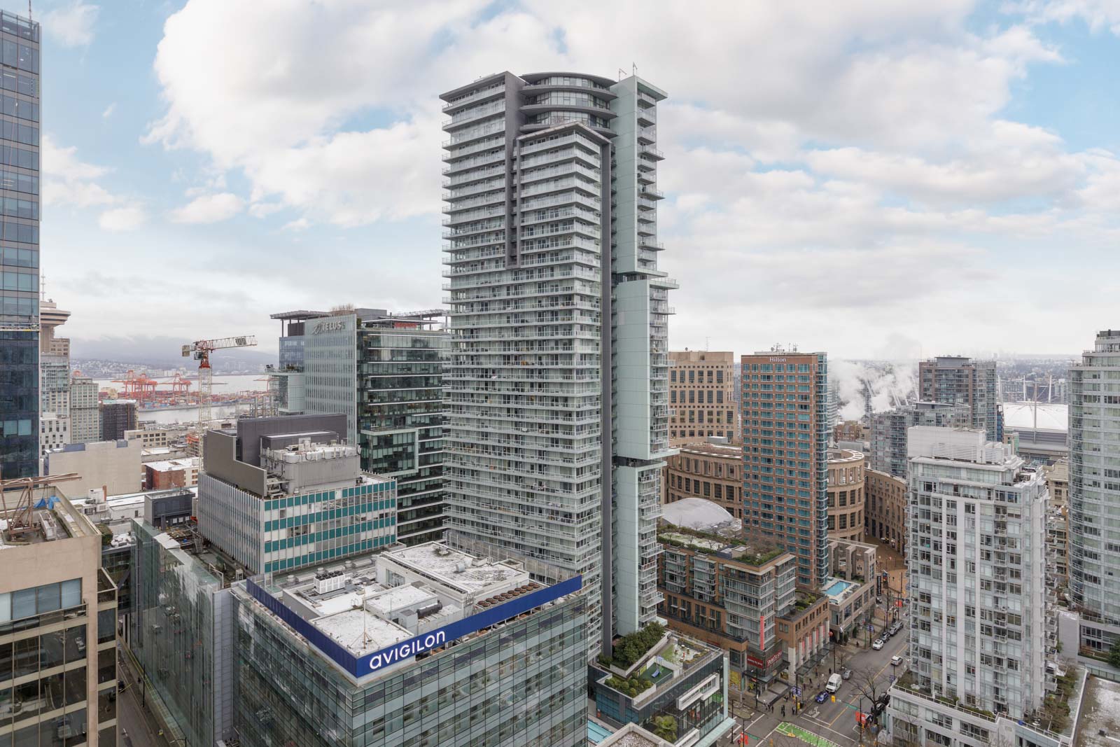 A cityscape showing multiple modern high-rise buildings, including one labeled 