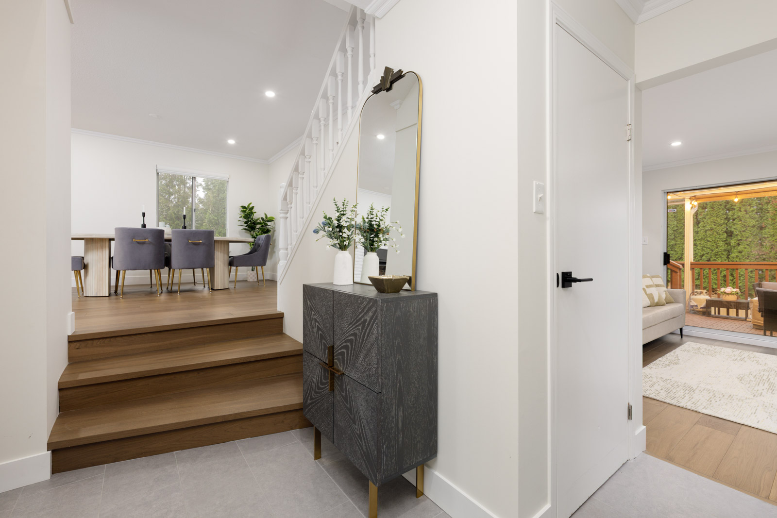 Styled entryway with split-level stairs and outdoor deck view in a Metro Vancouver rental house managed by Birds Nest Properties