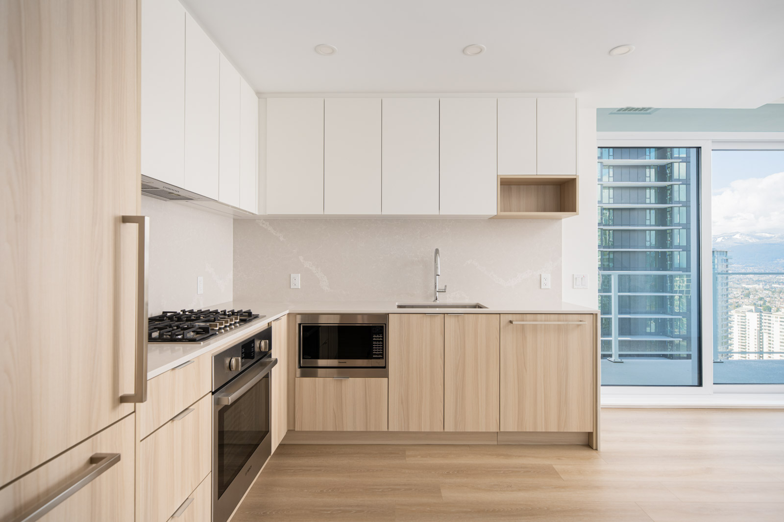 Modern kitchen in a Burnaby highrise condo rental property with mountain views, managed by Birds Nest Properties